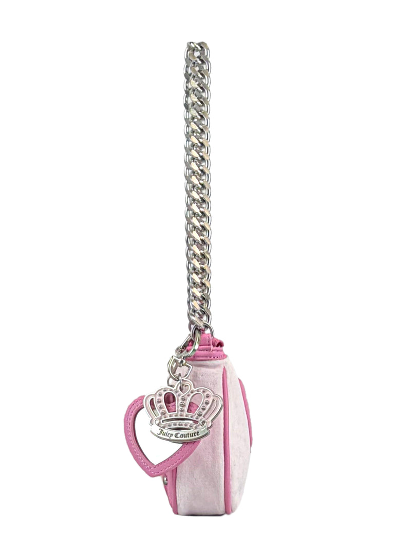 Side view of the Royal Bloom Shoulder Bag—a small pink Juicy Couture purse with a sleek shape, chunky silver chain strap, and a heart keychain featuring a crown and Juicy Couture logo for added glamour.