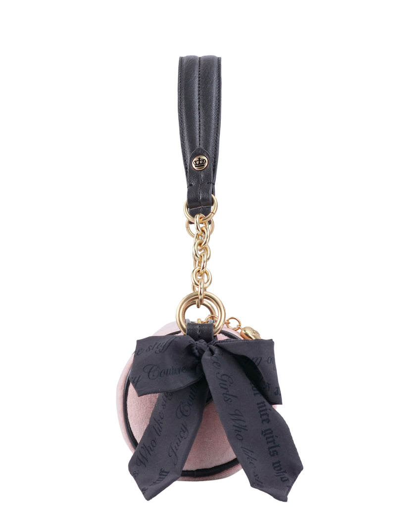 Crowns & Kisses Shoulder Bag in blush-pink, featuring a round shape, black ribbon bow, gold chain strap, and black leather handle, evoking a sense of feminine nostalgia.