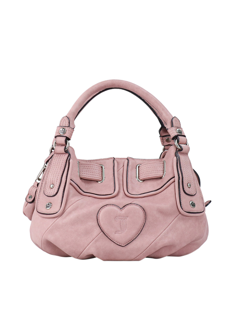 Pink Juicy Twist & Shout Crossbody Bag with a top handle, silver-tone hardware, and a heart-shaped patch featuring an embossed letter J on the front, perfect for everyday styling.
