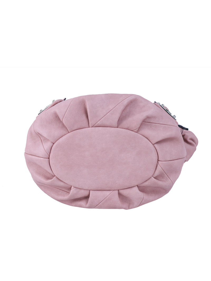 Light pink, rounded Twist & Shout Crossbody Bag with pleated detailing around a smooth oval center panel.