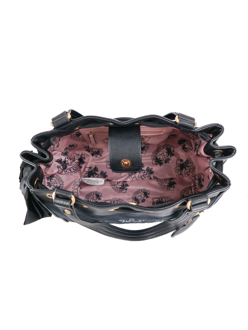 Overhead view of a black polished Scottie Heritage Daydreamer Tote Bag featuring a pink interior lining with a Scottie motif and a snap-button closure.