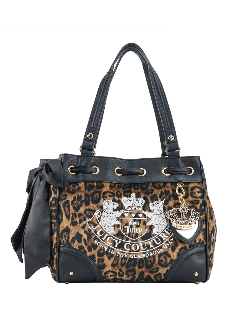 Scottie Heritage Daydreamer Tote Bag in leopard-print with black trim, a side bow, a signature Juicy charm, and a large screen-printed crest on the front.