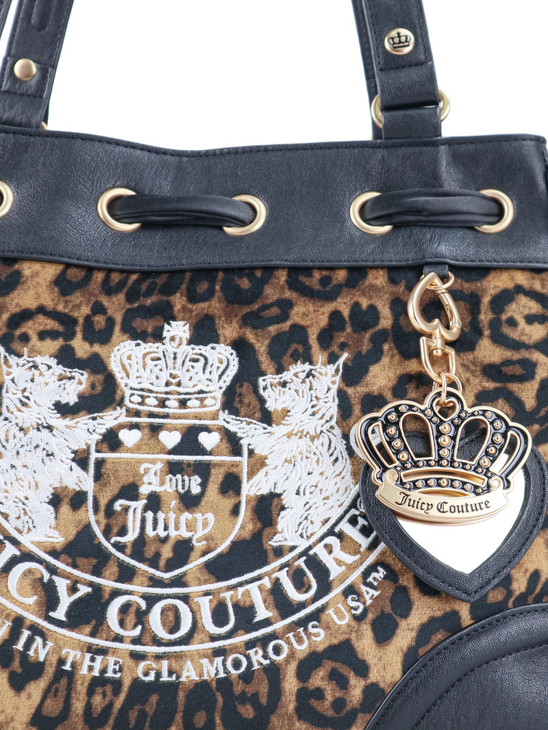 Scottie Heritage Daydreamer Tote Bag in leopard print with black trim, featuring a white embroidered Scottie crest and a dangling gold-tone crown charm.