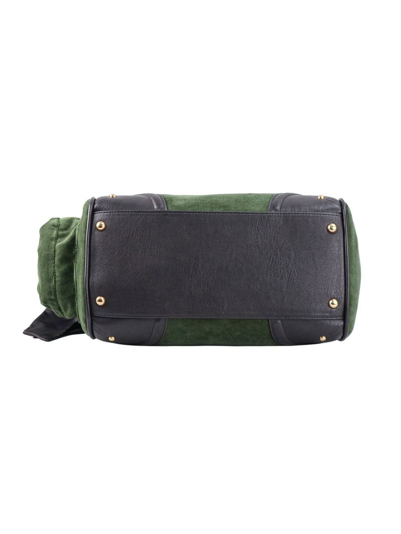 Bottom view of a green and black Scottie Heritage Daydreamer Tote Bag, featuring four gold-tone metal feet on a rectangular black base.