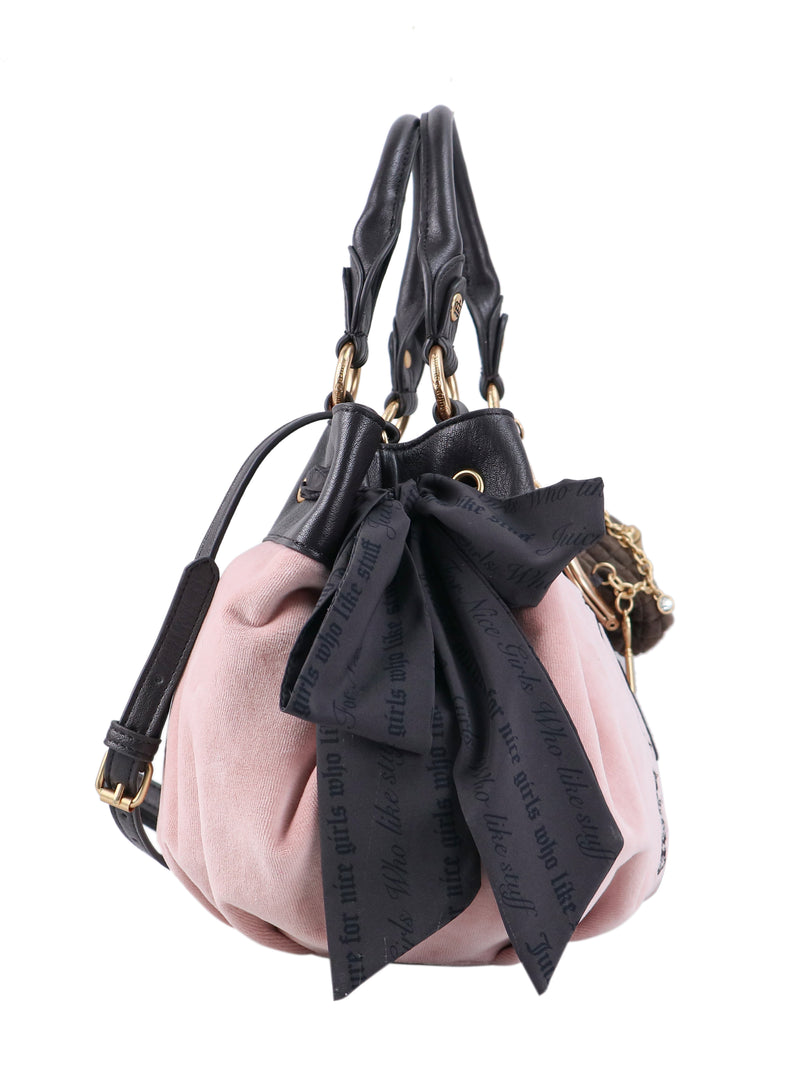 Crowns & Kisses Satchel Bag in pink, featuring black leather handles and trim, and a large black Y2K-style bow with repeating text.