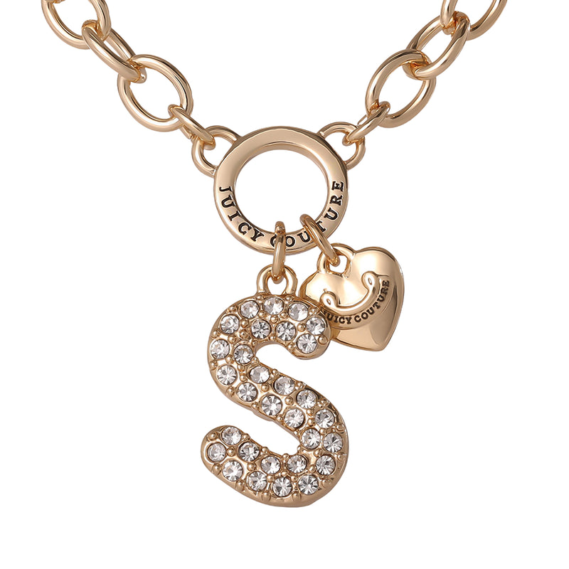 The Bubble Initial Necklace, Letter S features a gold chain with a round Juicy Couture logo charm, a heart-shaped charm, and a bold bubble letter S pendant embellished with sparkling clear rhinestones—making it a must-have personalized accessory that perfectly captures the playful spirit of Y2K jewelry.