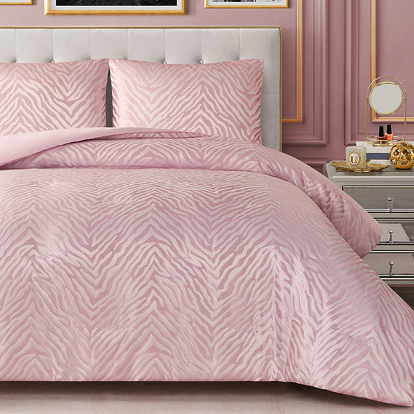 Pink zebra patterned bedding set on a bed with matching pillows, in a bedroom setting.