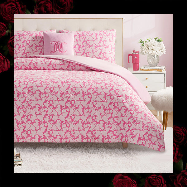Pink floral patterned bedding set with matching pillows in a bedroom setting.