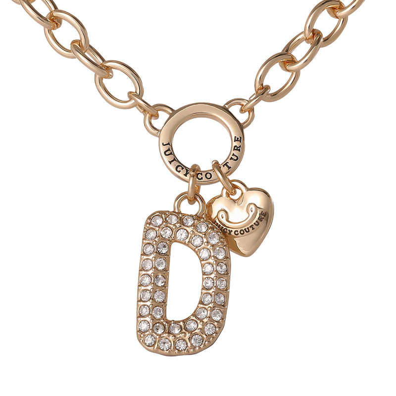 A Juicy Couture Bubble Initial Necklace in gold, inspired by the Y2K aesthetic, features a large crystal-studded letter D bubble initial charm and a small engraved gold heart charm with the brand name, all suspended from a circular link chain.