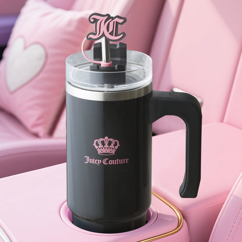 A black Jetsetter Hydration Stainless Steel Tumbler with handle sits in a pink cup holder, featuring a pink crown logo, JC straw topper, and matching the heart detail of the car, plus a neoprene crossbody pouch.