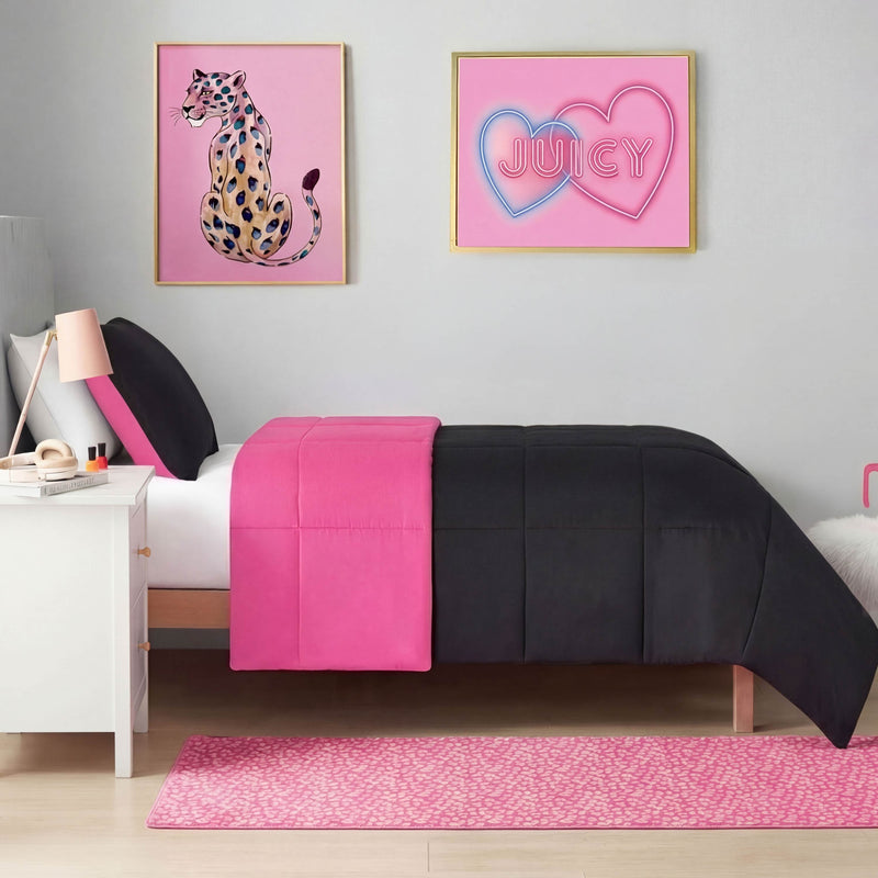A neatly made bed with black and hot pink bedding sits in a modern bedroom. Nearby is a Metallic Leopard Plush Rug, 2' x 6'. Above the bed are two framed pictures: a colorful cheetah and neon hearts with JUICY written inside. A white nightstand completes the look.