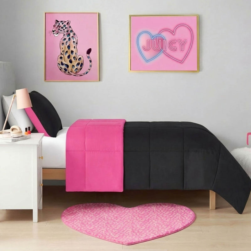 A modern bedroom with a single bed in black and hot pink bedding, a white nightstand, and a Metallic Leopard Plush Rug in a 3' heart shape. Wall art includes a leopard illustration and neon-style "JUICY" hearts for trendy flair.