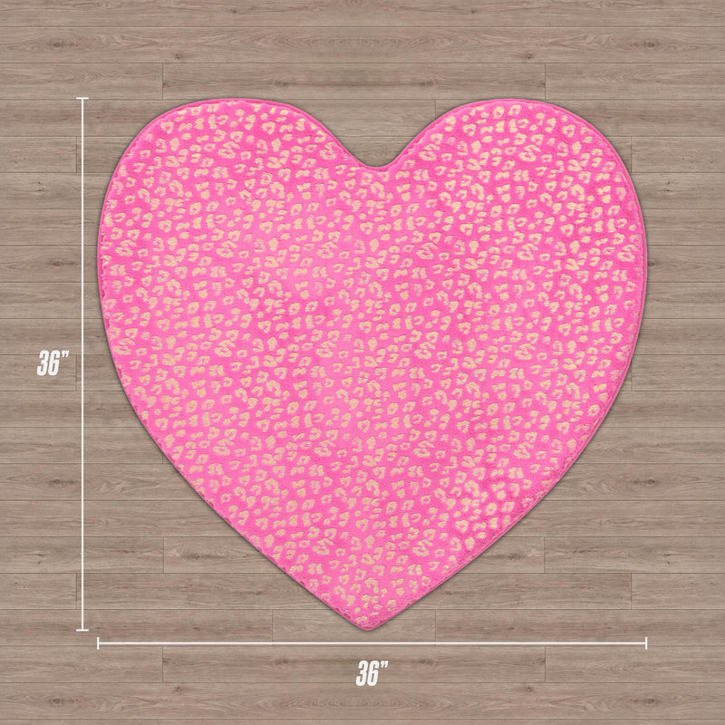 A Juicy Couture Metallic Leopard Plush Rug, 3' Heart, in pink with a gold metallic leopard print is placed on a wooden floor.