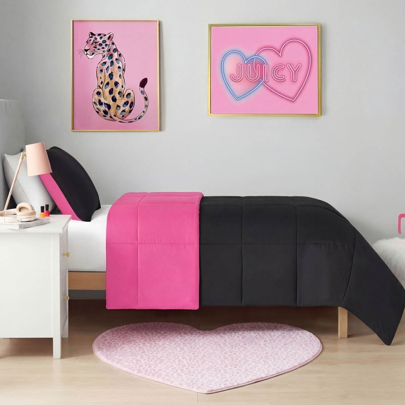 A neatly made bed with black and bright pink bedding stands against a gray wall, topped by leopard and neon double-heart artwork. On the floor is a Metallic Leopard Plush Rug in a 3' heart shape.