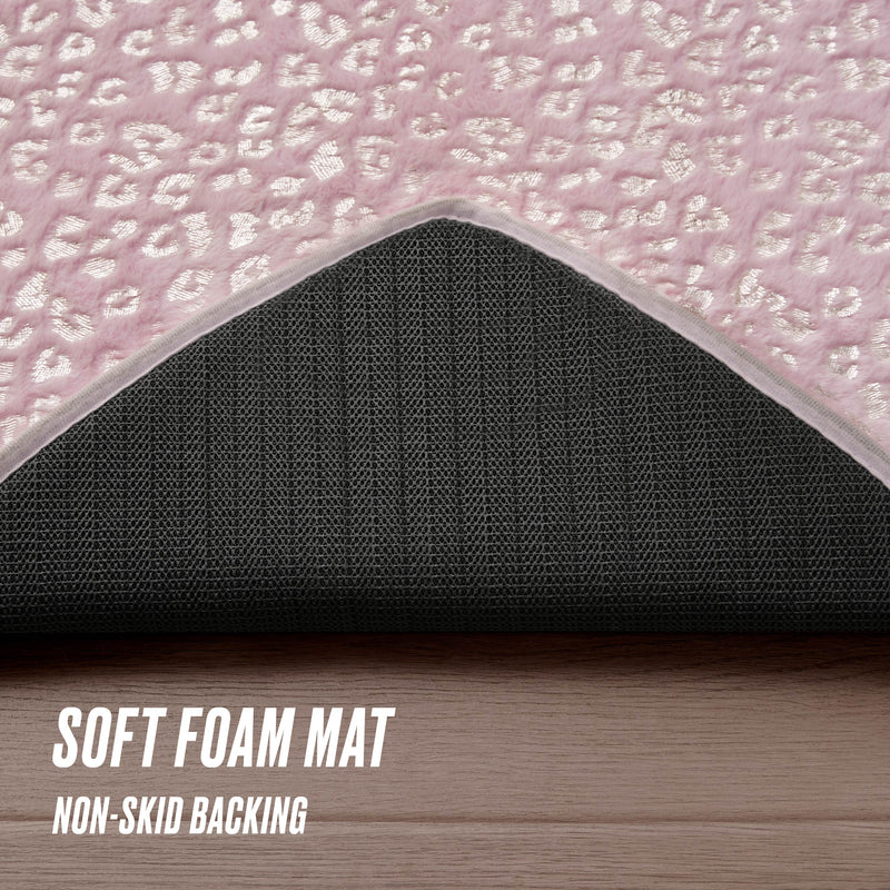 A close-up of the Metallic Leopard Plush Rug, 3' Heart, shows its hot pink textured top and black non-skid backing. SOFT FOAM MAT and NON-SKID BACKING text appears on the image. Ideal for fans of stylish rugs like Juicy Couture.