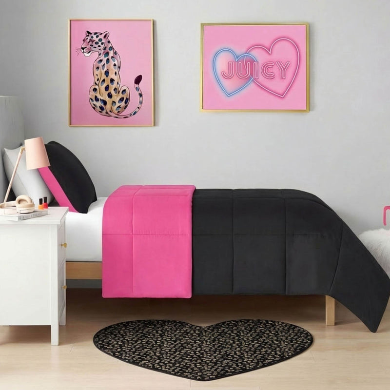 A modern bedroom with a white bed, black and bright pink bedding, a Metallic Leopard Plush Rug (3' heart-shaped), a white nightstand, and two pink wall art pieces—a cheetah and one with "JUICY" in heart outlines.