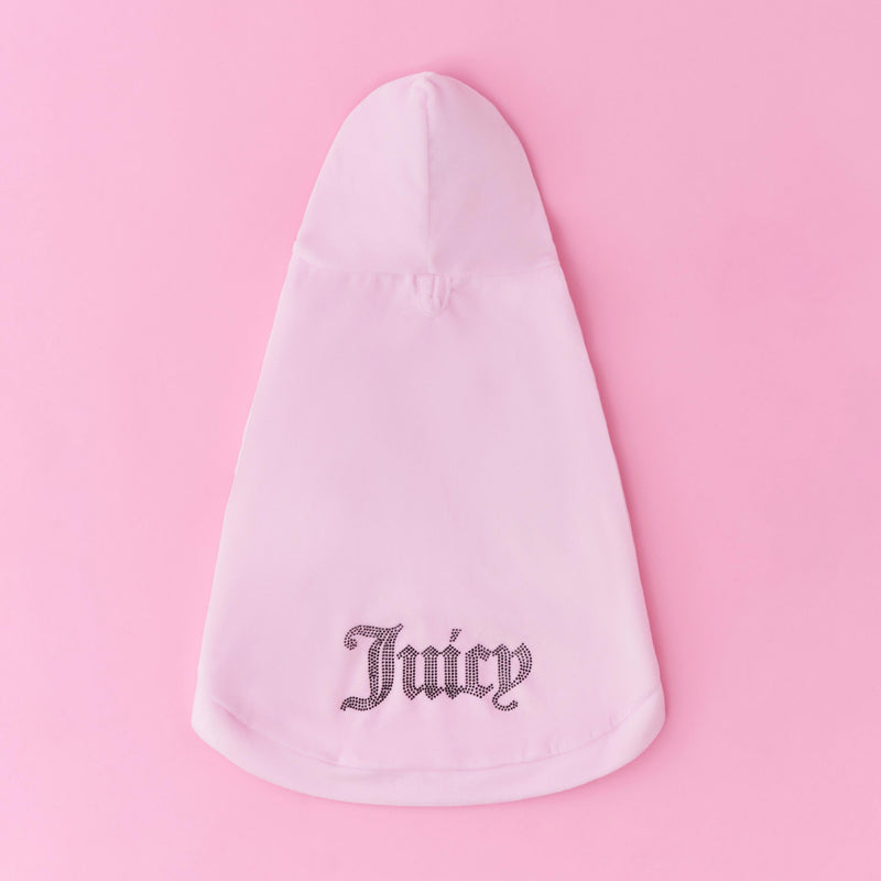 A blush pink Bling Velour Pet Hoodie is showcased on a pink backdrop, featuring the word “Juicy” in glittering silver script across the lower back. This stylish hoodie adds a touch of designer pet apparel flair to any fashionable furry companion.