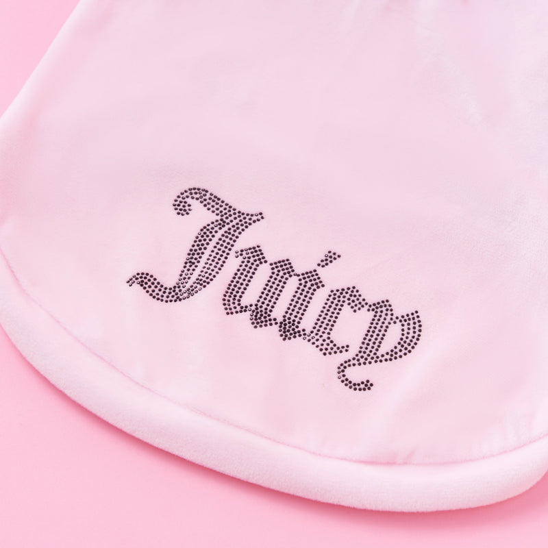 A close-up of a pink fabric featuring the word Juicy spelled out in rhinestones in a decorative font, showcasing the sparkle and charm of the Bling Velour Pet Hoodie—a must-have accessory for any stylish pet.