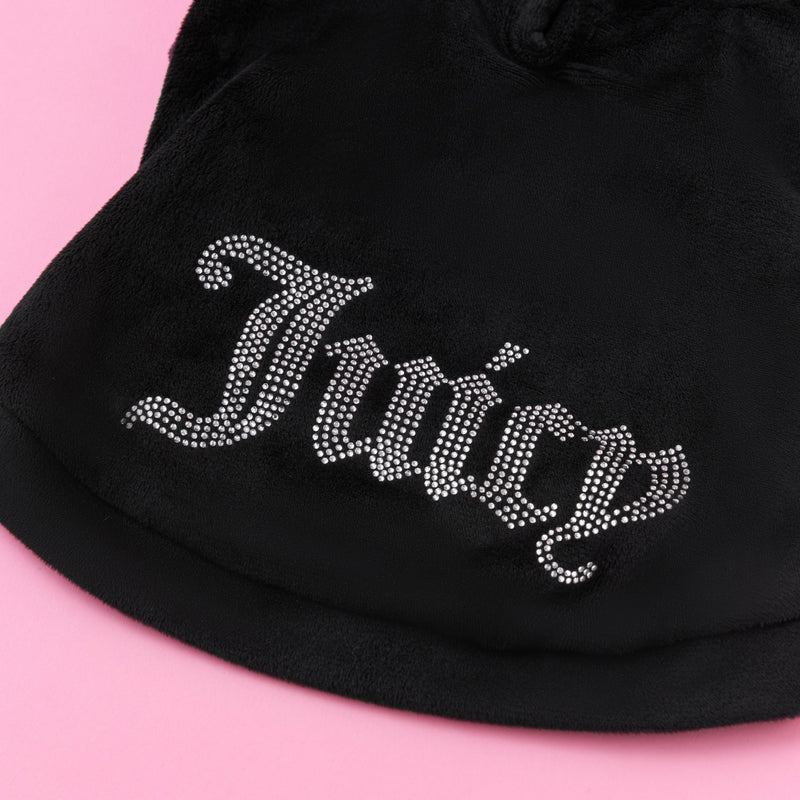 A close-up of a black velour fabric from the Bling Velour Pet Hoodie, featuring “Juicy” spelled out in rhinestones against a pink background—perfect for adding sparkle and style to your pet’s designer wardrobe.
