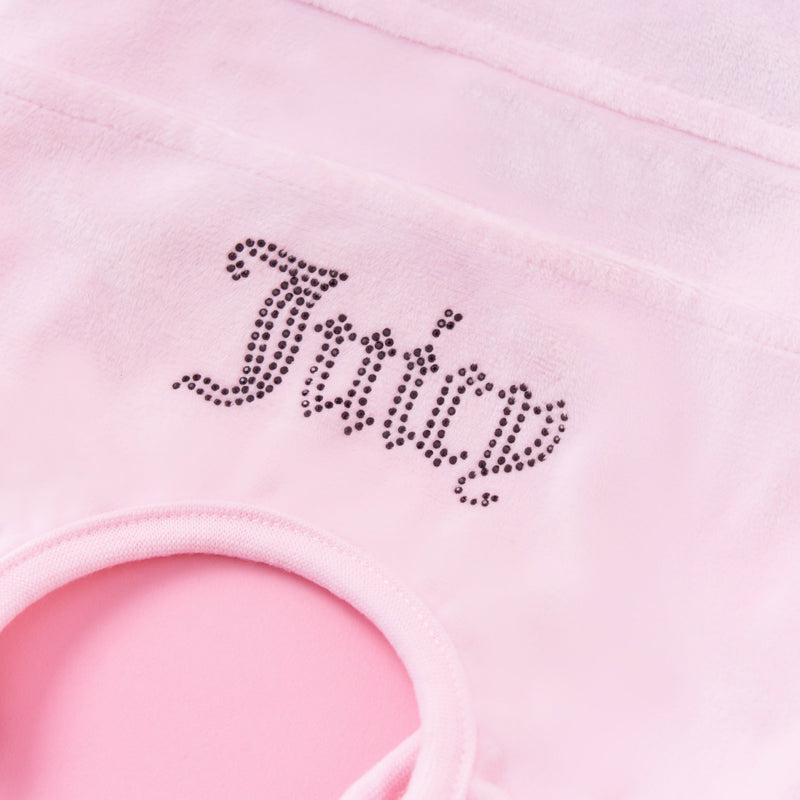 A close-up of the Bling Velour Pet Tracksuit in light pink shows ‘Juicy’ spelled out in small rhinestones and features a glimpse of its textured pink edging—ideal for stylish pet fashion or providing your pet with a cozy tracksuit.