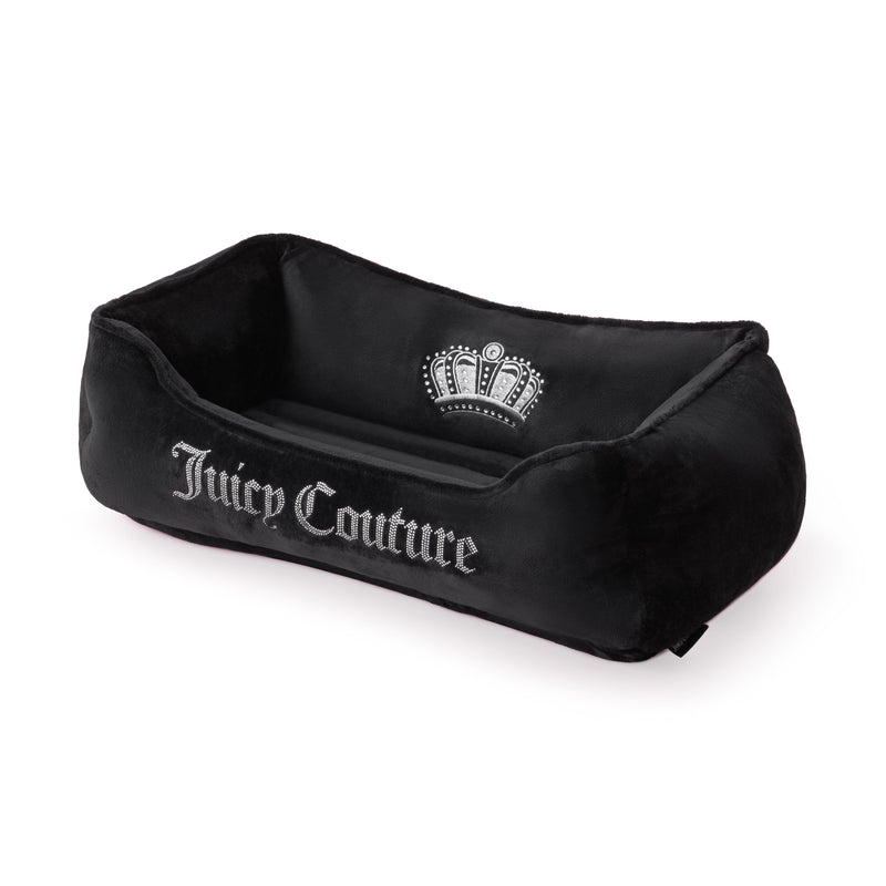 Introducing the Crown Bling Black Pet Bed—a luxurious black velour bed adorned with “Juicy Couture” in white along the side and featuring a striking white crown emblem on the backrest.