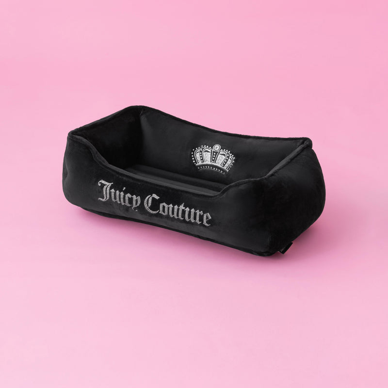 A Crown Bling Black Pet Bed with silver lettering and a crown logo sits on a pink background.