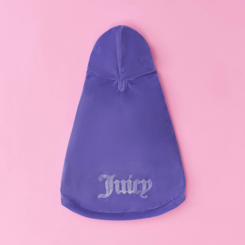 The Bling Velour Pet Hoodie, a purple hooded cape featuring “Juicy” spelled out in rhinestones along the hem, is displayed against a pink background.