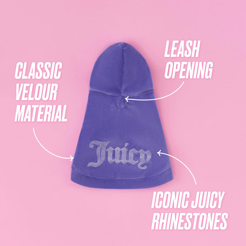 Introducing the Bling Velour Pet Hoodie: a purple Juicy Couture hoodie adorned with sparkling “Juicy” rhinestone lettering and crafted from classic velour. This stylish pet apparel features a handy leash opening and is shown against a pink background with its designer details clearly labeled—perfect for fashion-forward pups!.
