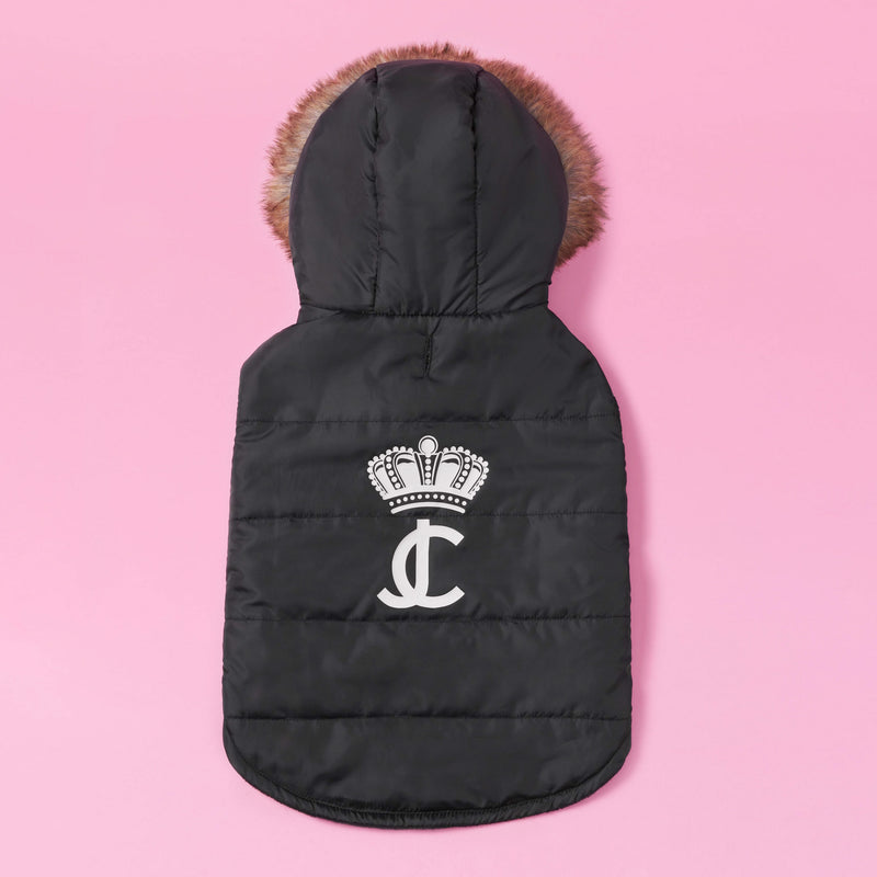 Certainly! Here is the revised sentence using your product data: The Pet Faux Fur Hooded Jacket, featuring a black design with a hood trimmed in faux fur and adorned with a white crown and JC logo on the back, makes for perfect cold-weather gear for dogs; it is displayed against a pink background.
