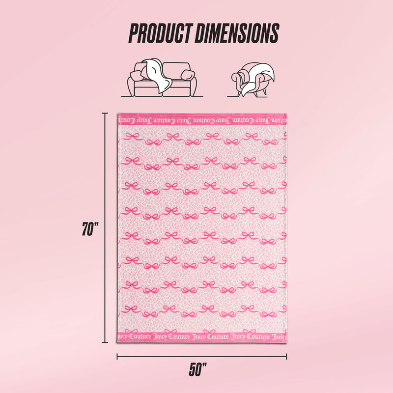 A light pink background showcases the Plush Throw Blanket by Juicy Couture in pink with bow patterns, measuring 70" x 50". Icons above indicate this ultra-soft blanket is perfect for sofas and beds.