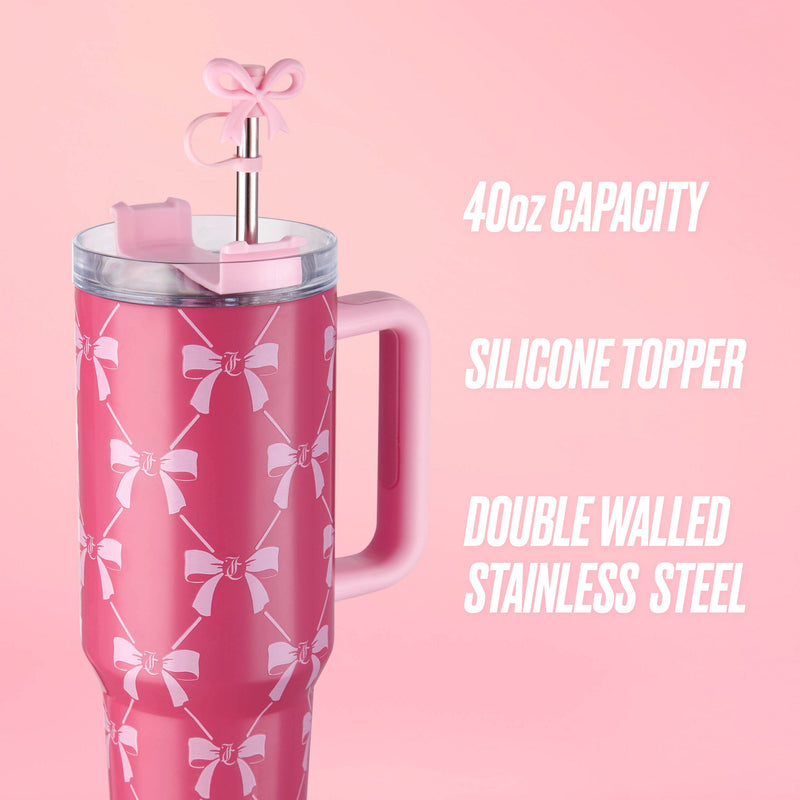 The Jetsetter Hydration Stainless Steel Tumbler, 40 oz, is a large pink cup with a handle and white bow decor, plus a silicone bow topper on the straw. Double-walled stainless steel keeps drinks cold, making it perfect for travel.