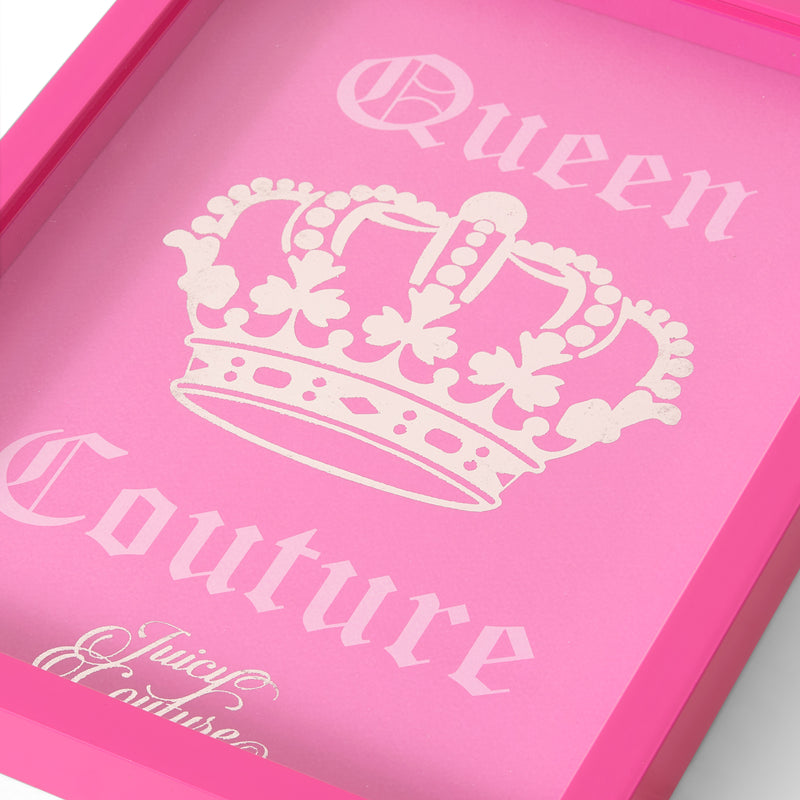 A pink frame featuring “Queen Couture” in white Gothic font and a white crown graphic at the center, this Shadow Box Wall Art (12″ x 16″) makes a striking statement as Juicy Couture wall décor. The lower corner displays part of the Juicy Couture logo, blending fashion-inspired artwork into unique shadow box art for any chic space.