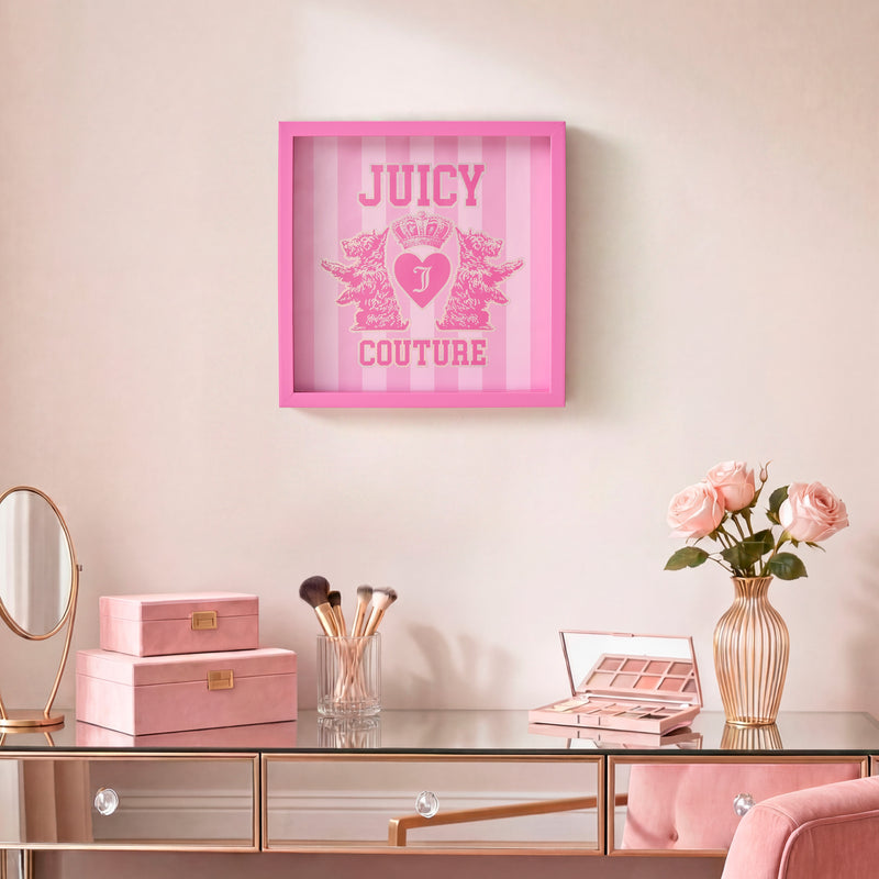 A vanity table with makeup items, a pink vase with roses, and pink storage boxes is topped off by the elegant and feminine Shadow Box Wall Art, 14″ x 14″, in pink, hanging above.