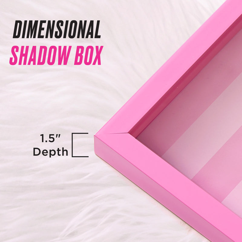 A pink Shadow Box Wall Art, measuring 14″ x 14″ with a 1.5-inch depth, rests on a white furry surface—perfect for showcasing your shadow box art. Text reads DIMENSIONAL SHADOW BOX and 1.5″ Depth, with a diagram highlighting the depth—ideal for displaying your fashion-inspired artwork or Juicy Couture wall art in style.