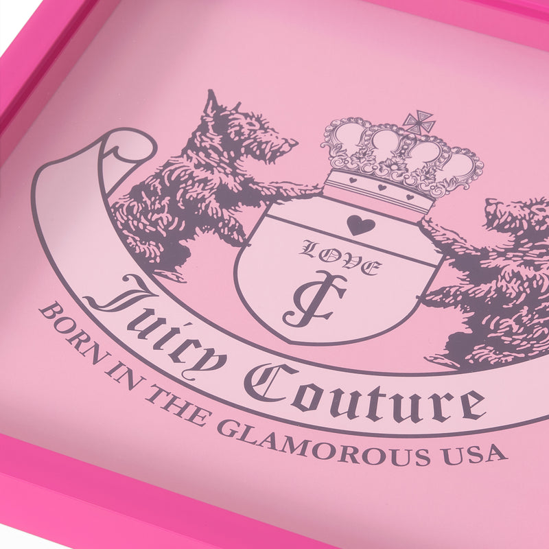 Close-up of a pink Juicy Couture logo featuring two dogs, a crown, and text reading “LOVE G & P,” “Juicy Couture,” and “BORN IN THE GLAMOROUS USA.” This eye-catching Shadow Box Wall Art (14″ x 14″) captures the brand’s iconic style in fashion-inspired artwork, perfect for adding glam to any space.