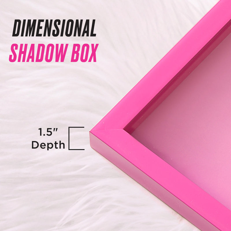 A close-up of a pink Shadow Box Wall Art, 14″ x 14″, on white fur, with text reading Dimensional Shadow Box and 1.5 Depth to highlight the frame’s depth—ideal for displaying Juicy Couture wall art or any fashion-inspired pieces in a striking shadow box art style.