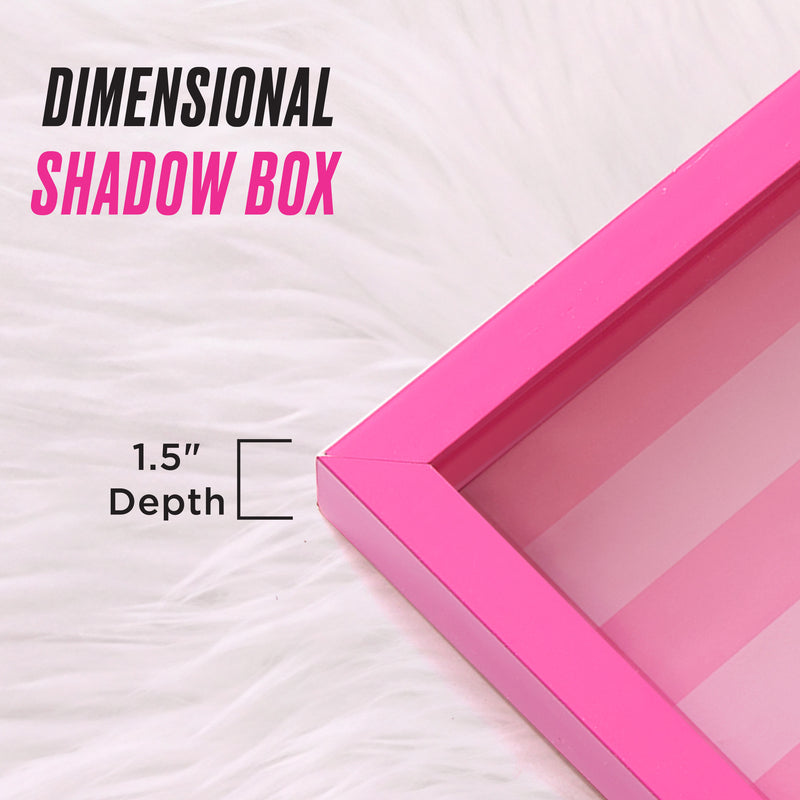 A Shadow Box Wall Art, 12″ x 16″ with a chic pink frame and a 1.5-inch depth is displayed on a white fur background. The text reads “Dimensional Shadow Box” and “1.5 Depth,” making it ideal for showcasing your favorite fashion-inspired artwork or creating unique shadow box art displays.