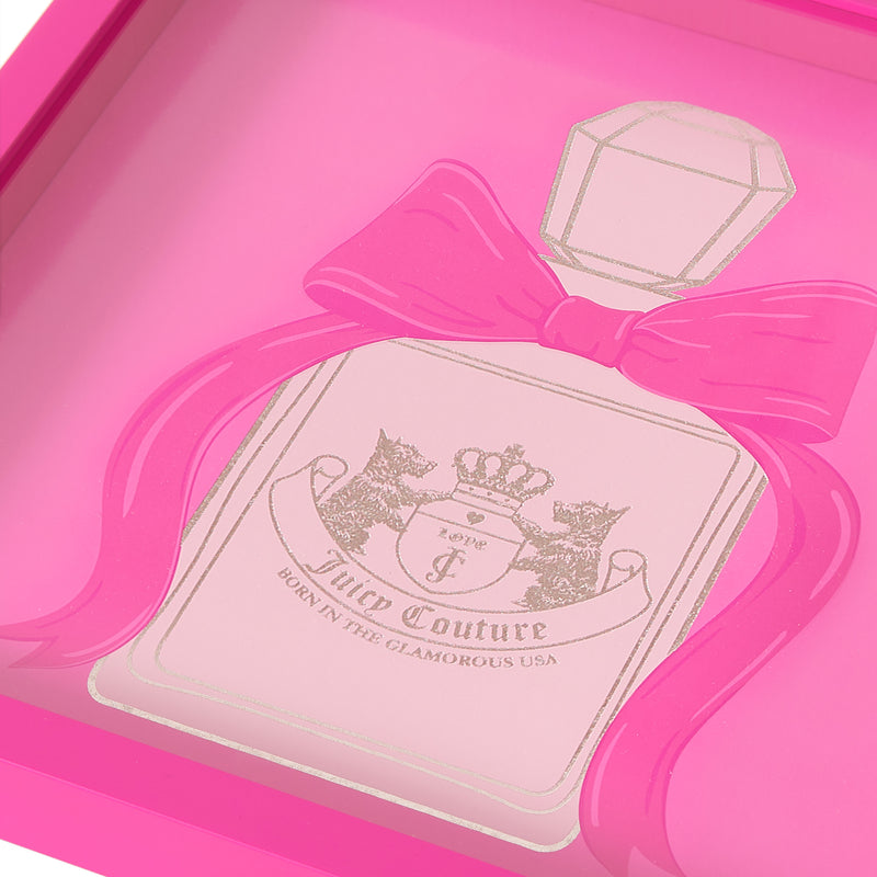 A close-up of a pink Juicy Couture perfume bottle illustration featuring a large bow and a decorative label that reads “Born in the Glamorous USA,” beautifully showcased as Shadow Box Wall Art, 14″ x 14″—perfect for adding fashionable, Juicy Couture-inspired flair to any space.