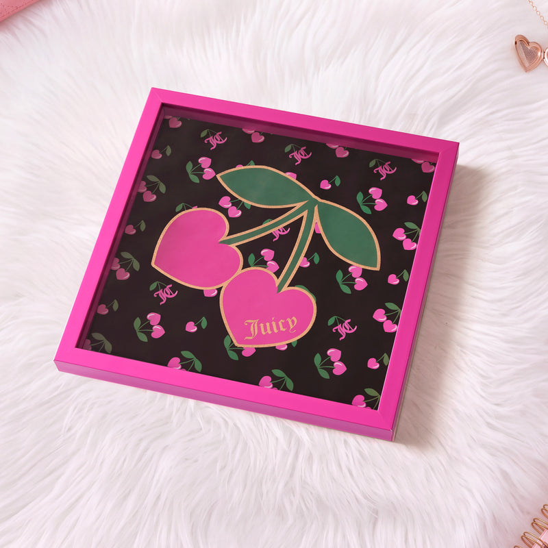 Introducing the Shadow Box Wall Art, 14″ x 14″—a pink-framed display featuring vibrant cherry artwork with “Juicy” written on one of the cherries. Set against a furry white background with chic pink and gold accents, this Juicy Couture-inspired piece brings playful charm and bold style to any room.