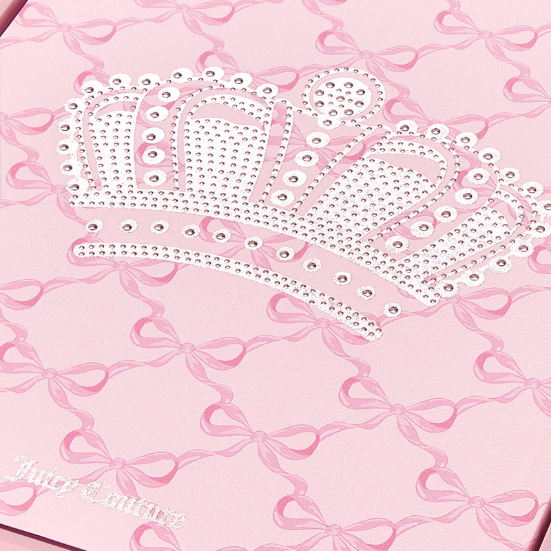 Featuring a chic pink background adorned with a repeating bow pattern, this Shadow Box Wall Art (16″ x 20″) showcases a large, sparkling rhinestone crown and the Juicy Couture logo in crisp white text in the bottom left corner—perfect for adding a touch of fashion-inspired flair to any space.