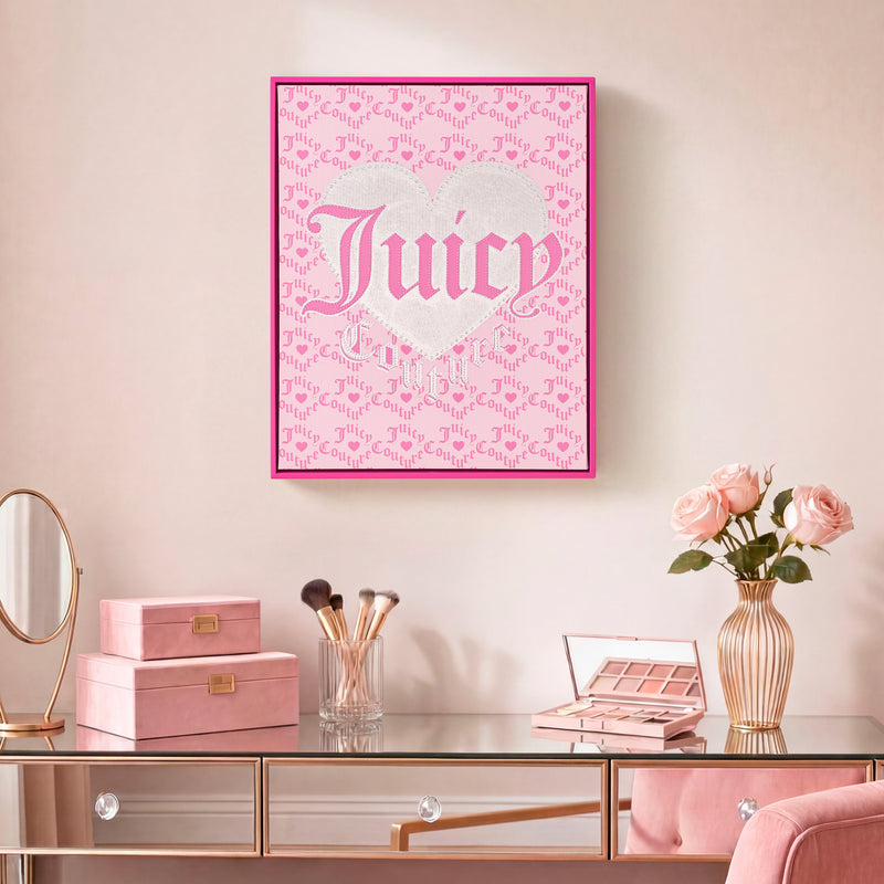 A vanity adorned with pink makeup items and brushes sits beneath the Shadow Box Wall Art, 16″ x 20″, featuring ornate silver and pink lettering. A vase of pink roses decorates the mirrored surface, while the fashion-inspired artwork adds a playful touch of glamour to the space.