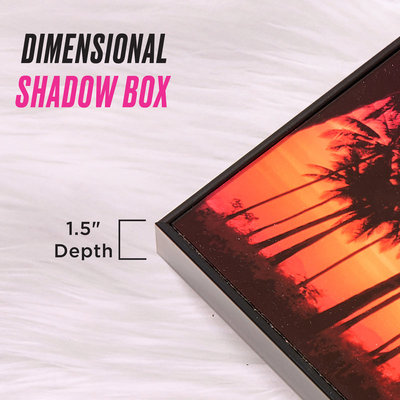 A close-up of the Shadow Box Wall Art, 18″ x 24″, featuring a framed sunset art print with palm trees and overlay text reading “Dimensional Shadow Box” and “1.5 Depth,” displayed on a white fur background, capturing the vibrant energy of shadow box and fashion-inspired artwork.