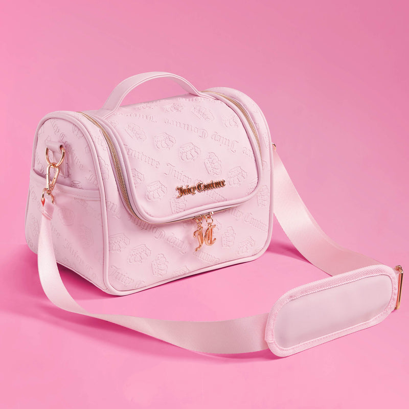 A light pink Lunch Purse Cooler Bag featuring embossed Juicy Couture logos, gold hardware, a top handle, and a wide shoulder strap—this chic insulated tote keeps your essentials fresh while adding a fashionable touch. Set against a solid pink background.