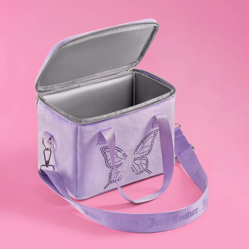 A light purple Chill Couture Cooler Bag by Juicy Couture, featuring a butterfly design, silver zipper, and adjustable strap, sits open on a pink background. This stylish lunch tote stands out for its chic look while keeping your meals fresh throughout the day.