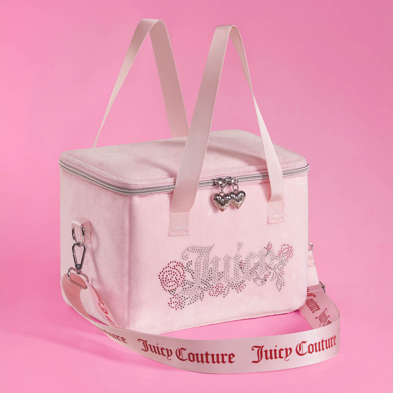 A pink Chill Couture Cooler Bag featuring a sparkling rhinestone Juicy Couture logo, pink handles, and a detachable strap adorned with “Juicy Couture” lettering. Set against a matching pink background, this stylish lunch tote doubles as an insulated cooler bag—perfect for keeping your meals fresh and chic wherever you go.