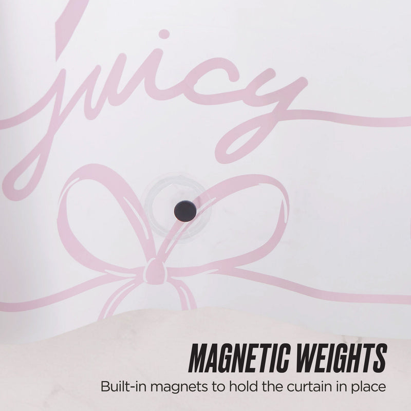 A close-up of a PEVA Shower Curtain Liner with the word "juicy" and a pink bow design. A small round magnet is visible, and text at the bottom reads, MAGNETIC WEIGHTS Built-in magnets to keep this waterproof curtain in place.