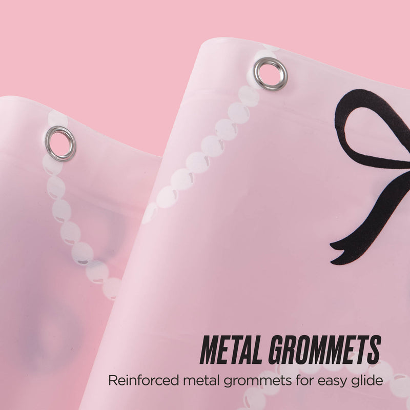 Close-up of the PEVA Shower Curtain Liner with reinforced metal grommets for smooth movement, shown in pink with a stylish black bow print. Text: Metal Grommets—Reinforced for easy glide.