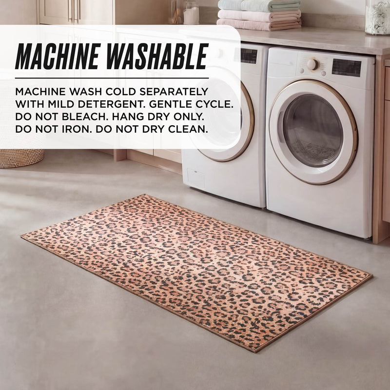 A Finely Washable Rug, 2' x 4', with an ultra-soft leopard print is placed before a washer and dryer. Text overlay: machine wash cold, gentle cycle, hang dry only; do not bleach, iron, or dry clean.