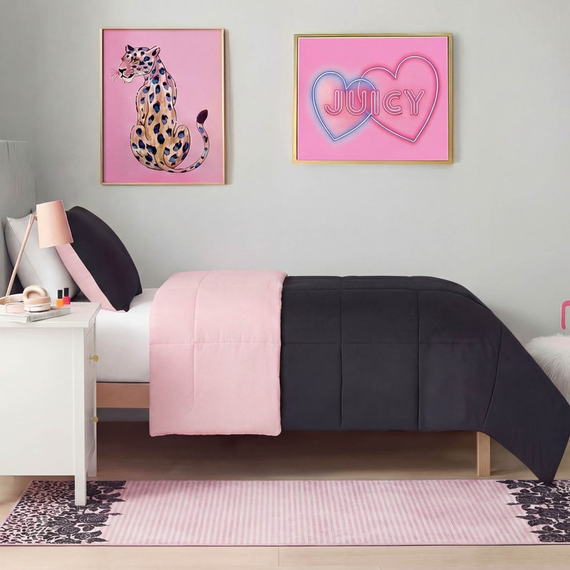 A neatly made bed with a pink and dark gray comforter, a white nightstand with a lamp, cheetah and “JUICY” hearts wall art above the bed, and the Finely Washable Rug, 2' x 6', adds an ultra-soft, cozy touch.