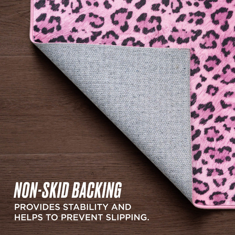 The Finely Washable Rug, 2' x 4', features a pink and black leopard print with a textured gray non-skid backing for stability and slip prevention.